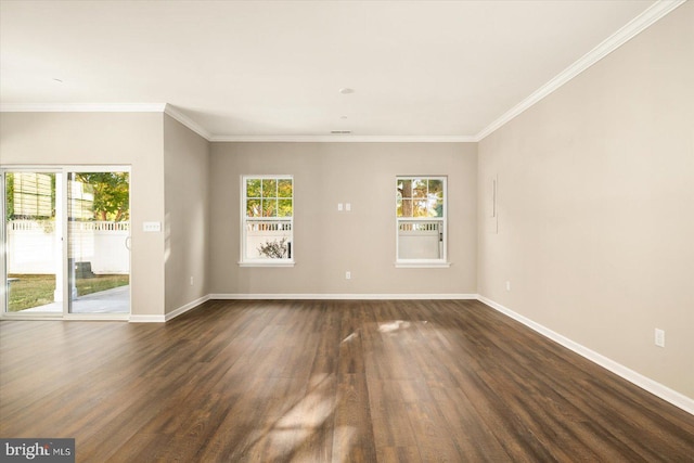 spare room with ornamental molding and dark hardwood / wood-style flooring