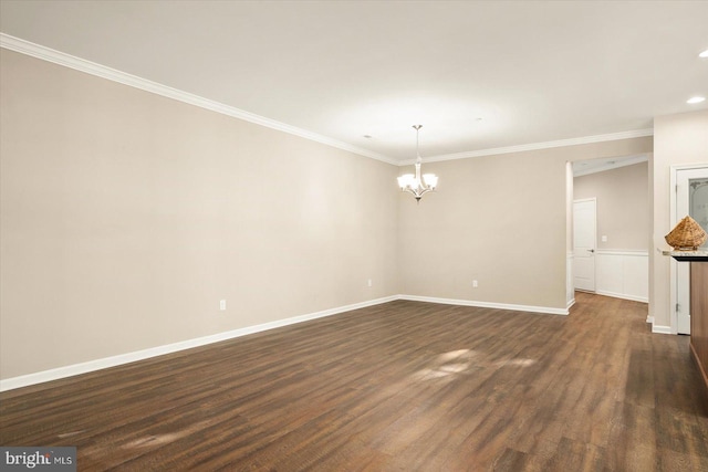 unfurnished room featuring a notable chandelier, ornamental molding, and dark wood-type flooring