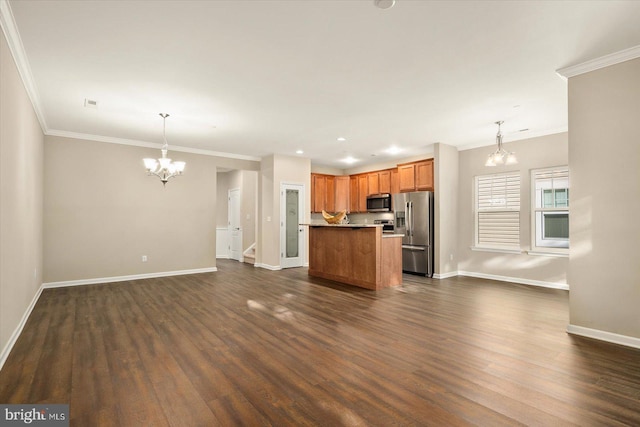 kitchen featuring ornamental molding, dark wood-type flooring, decorative light fixtures, and stainless steel appliances