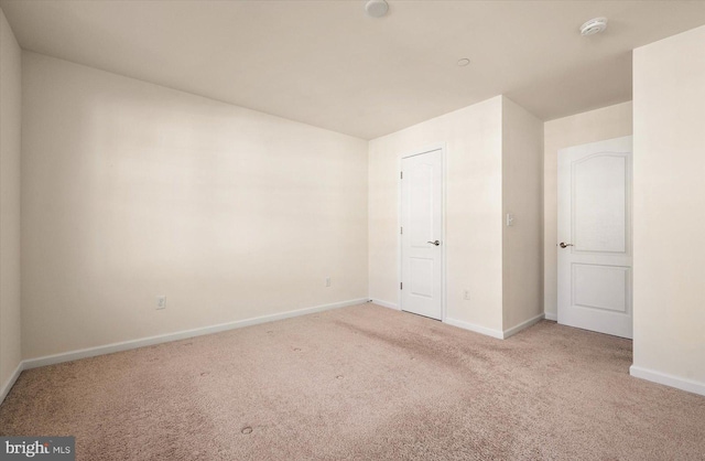 unfurnished room with light colored carpet