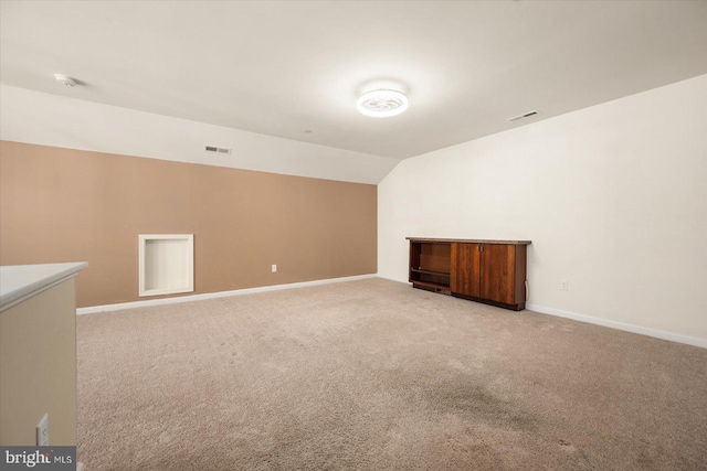 additional living space featuring light carpet and lofted ceiling