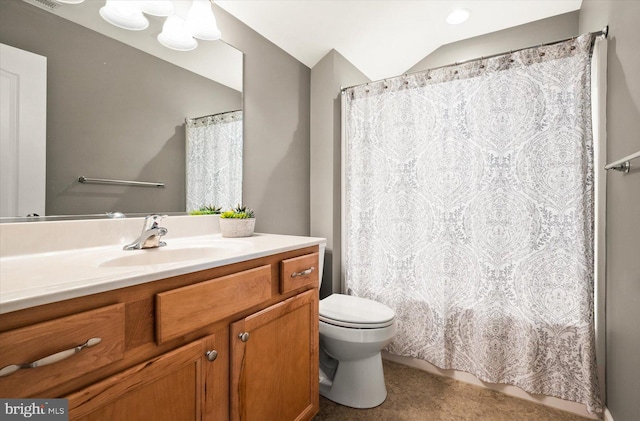 bathroom with vanity, toilet, and vaulted ceiling