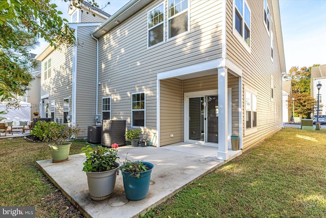 back of house with a yard and a patio area