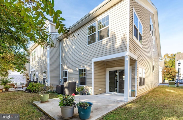 back of house with a yard and a patio area