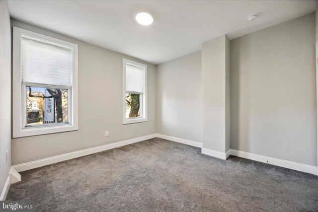 empty room featuring dark colored carpet