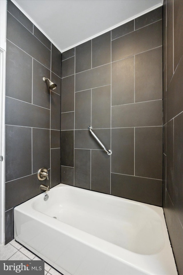 bathroom featuring tile patterned flooring and tiled shower / bath