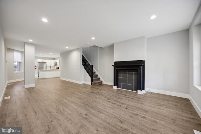 unfurnished living room with light hardwood / wood-style flooring