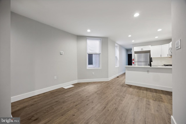 unfurnished living room featuring light wood-type flooring