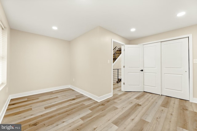 basement with light hardwood / wood-style flooring