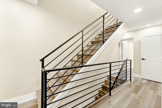 staircase with wood-type flooring