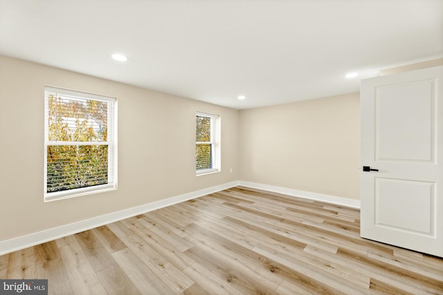 spare room featuring light wood-type flooring