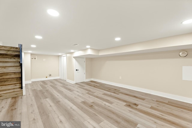 basement with light hardwood / wood-style floors