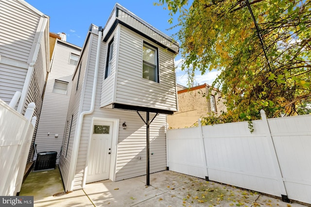 back of property with a patio area and central AC unit