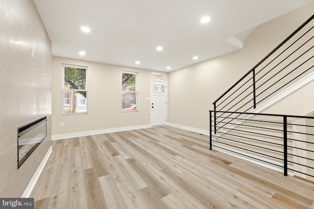 unfurnished living room featuring light wood-type flooring