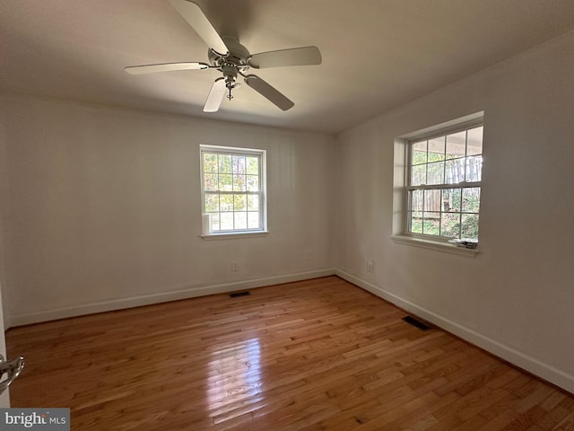 unfurnished room with hardwood / wood-style floors and ceiling fan