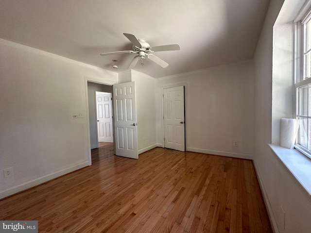 empty room featuring hardwood / wood-style floors and ceiling fan