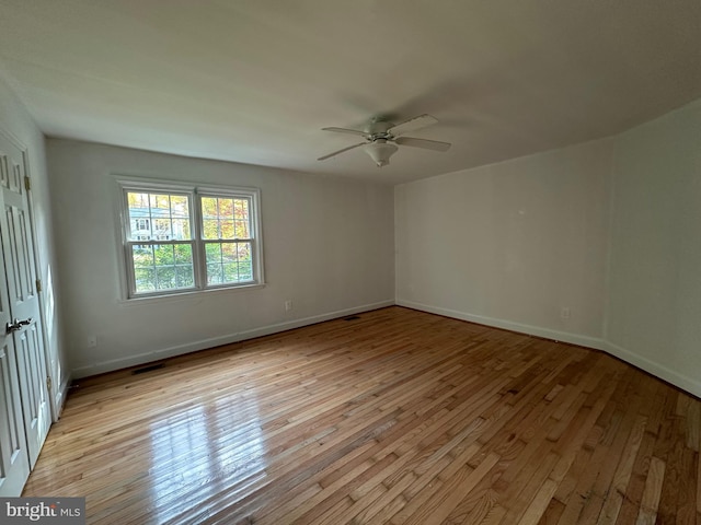 spare room featuring light wood-type flooring and ceiling fan