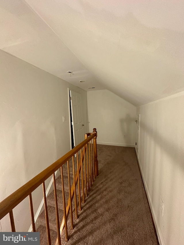 bonus room with dark carpet and lofted ceiling