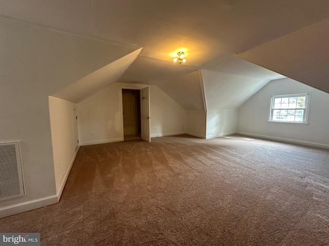 bonus room featuring lofted ceiling and carpet