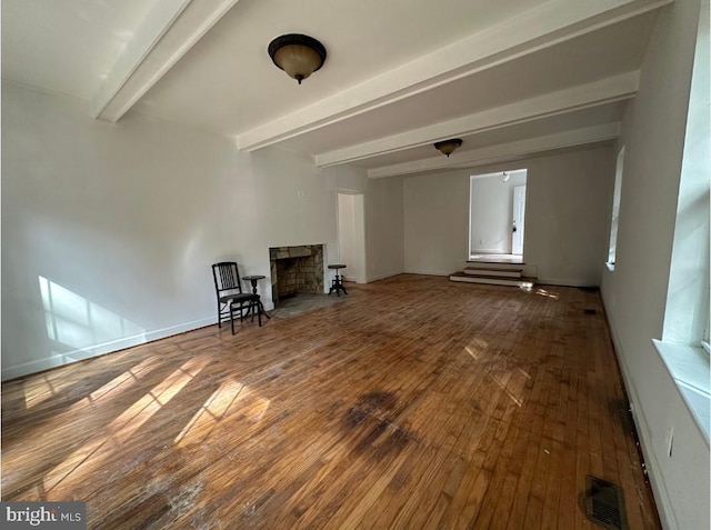 unfurnished room featuring beamed ceiling and wood-type flooring