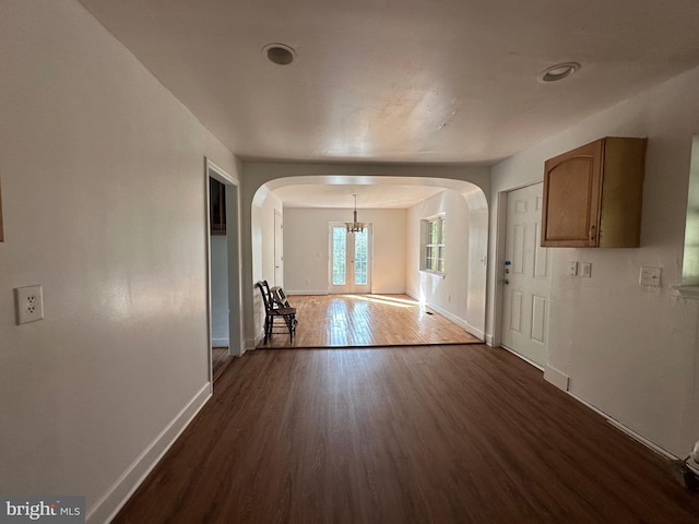 interior space featuring an inviting chandelier and dark hardwood / wood-style floors