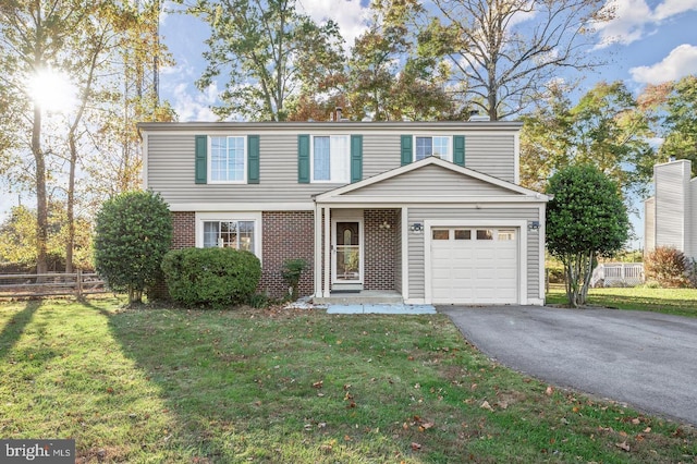 view of front property featuring a front yard and a garage