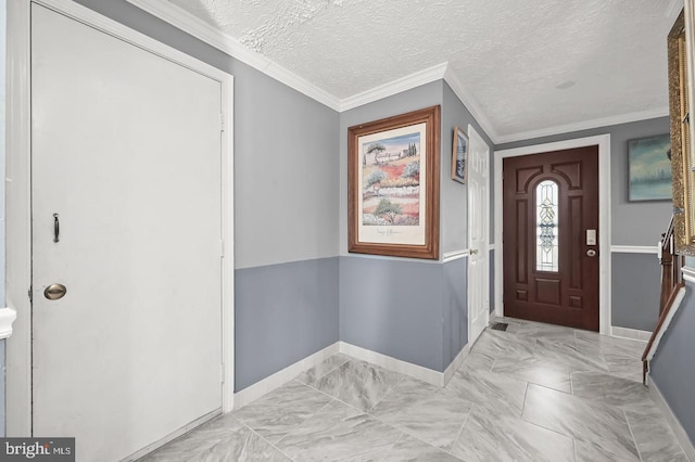 foyer featuring crown molding and a textured ceiling