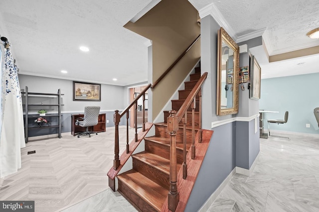 stairs featuring ornamental molding and a textured ceiling