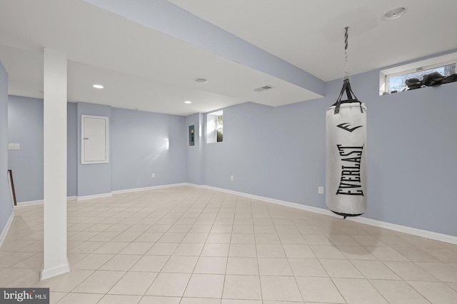 basement with plenty of natural light and light tile patterned flooring