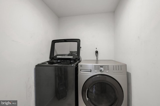 clothes washing area featuring separate washer and dryer