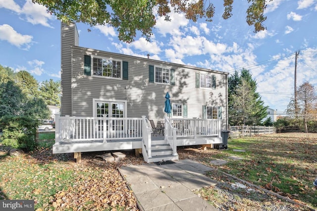 rear view of house featuring a wooden deck