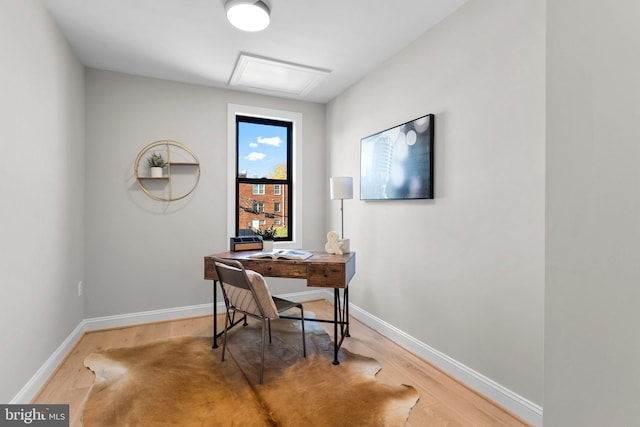 home office with hardwood / wood-style flooring