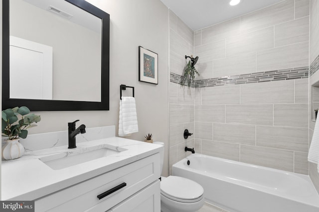 full bathroom featuring vanity, toilet, and tiled shower / bath combo