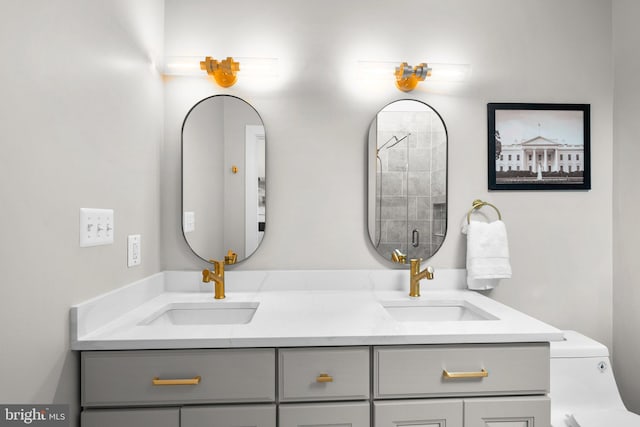 bathroom featuring vanity, a shower with shower door, and toilet