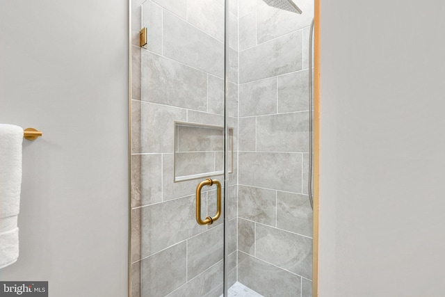 bathroom with a shower with shower door