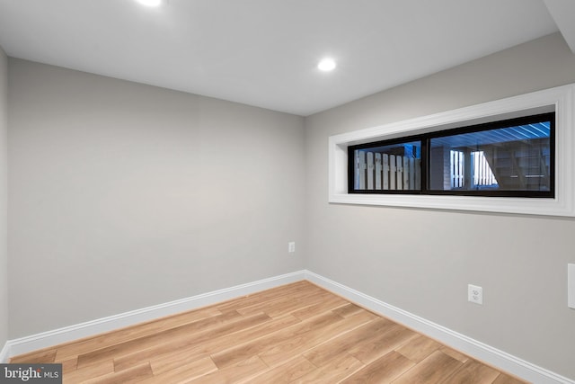 unfurnished room with hardwood / wood-style flooring