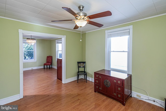 sitting room featuring light hardwood / wood-style floors and crown molding