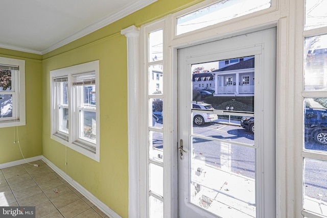 entryway with crown molding and tile patterned floors