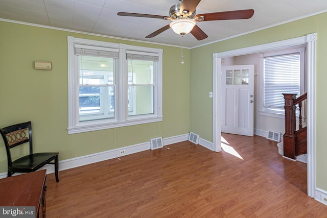 entrance foyer with crown molding, hardwood / wood-style flooring, and ceiling fan