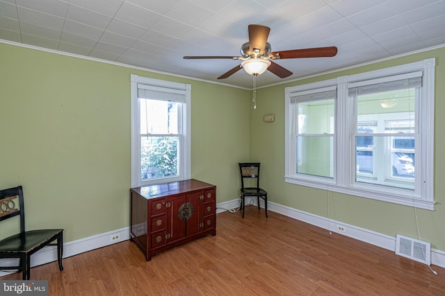 sitting room with crown molding, light hardwood / wood-style flooring, and ceiling fan