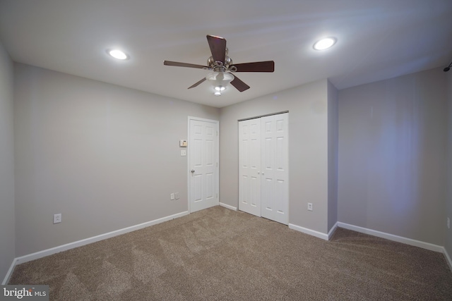 unfurnished bedroom with carpet, a closet, and ceiling fan