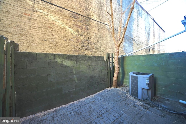 view of home's exterior with a patio area and central AC