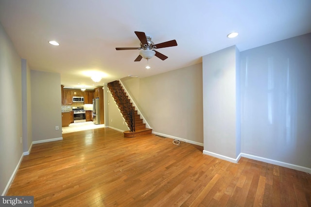 unfurnished living room featuring light hardwood / wood-style flooring and ceiling fan