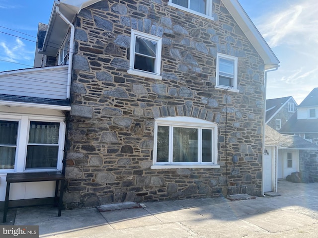 view of property exterior with a patio area