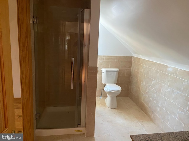 bathroom with toilet, tile walls, and an enclosed shower