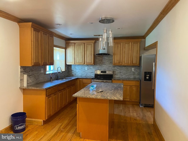 kitchen featuring a kitchen island, wall chimney range hood, stainless steel appliances, and light hardwood / wood-style floors