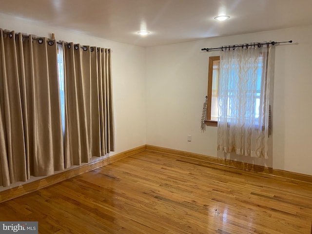 spare room featuring wood-type flooring