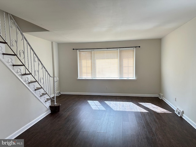 empty room featuring dark hardwood / wood-style flooring