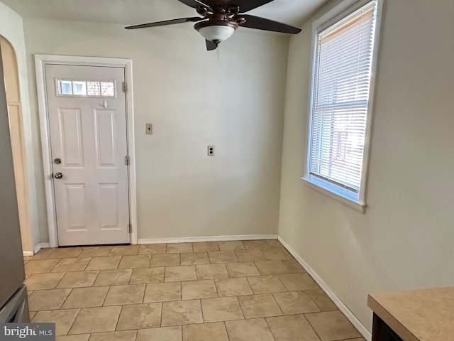 foyer with ceiling fan and light tile patterned floors