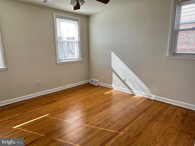 unfurnished room featuring ceiling fan and hardwood / wood-style floors